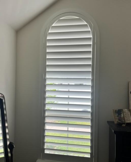 Tall arched plantation shutter